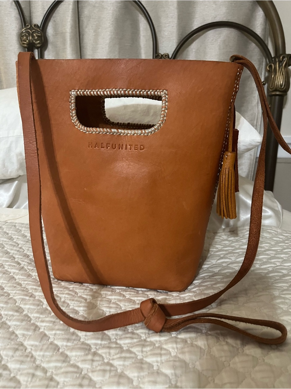 Half United Cognac Leather Crossbody Bucket Bag with Tassel